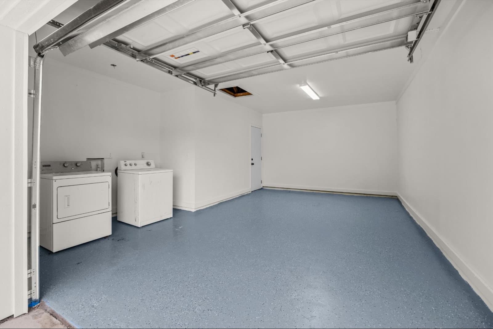 After: a clean, repaired garage with fresh epoxy flooring