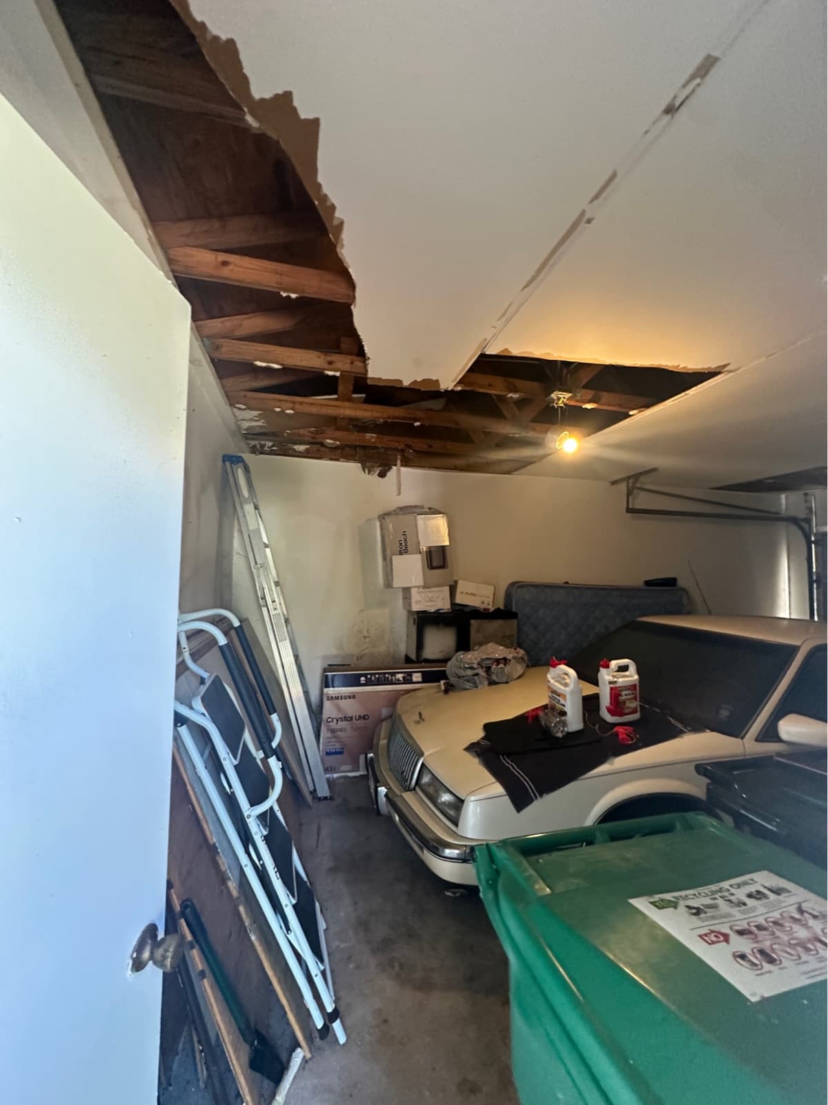 The garage before: a water-damaged, collapsing ceiling and stored clutter